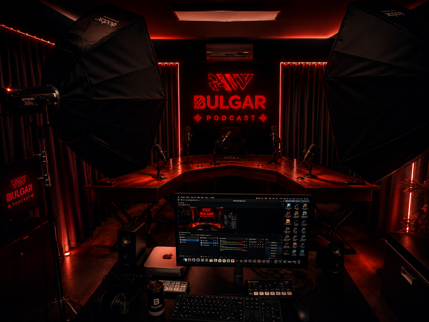 The studio: a curved four-seat desk with broadcast microphones and softboxes either side, lit red beneath a neon RAW BULGAR PODCAST sign.